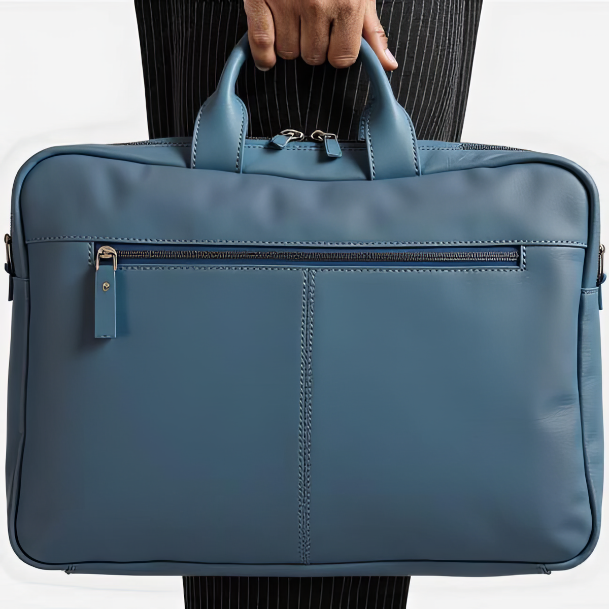 Blue briefcase held by a person wearing a suit, on a white background